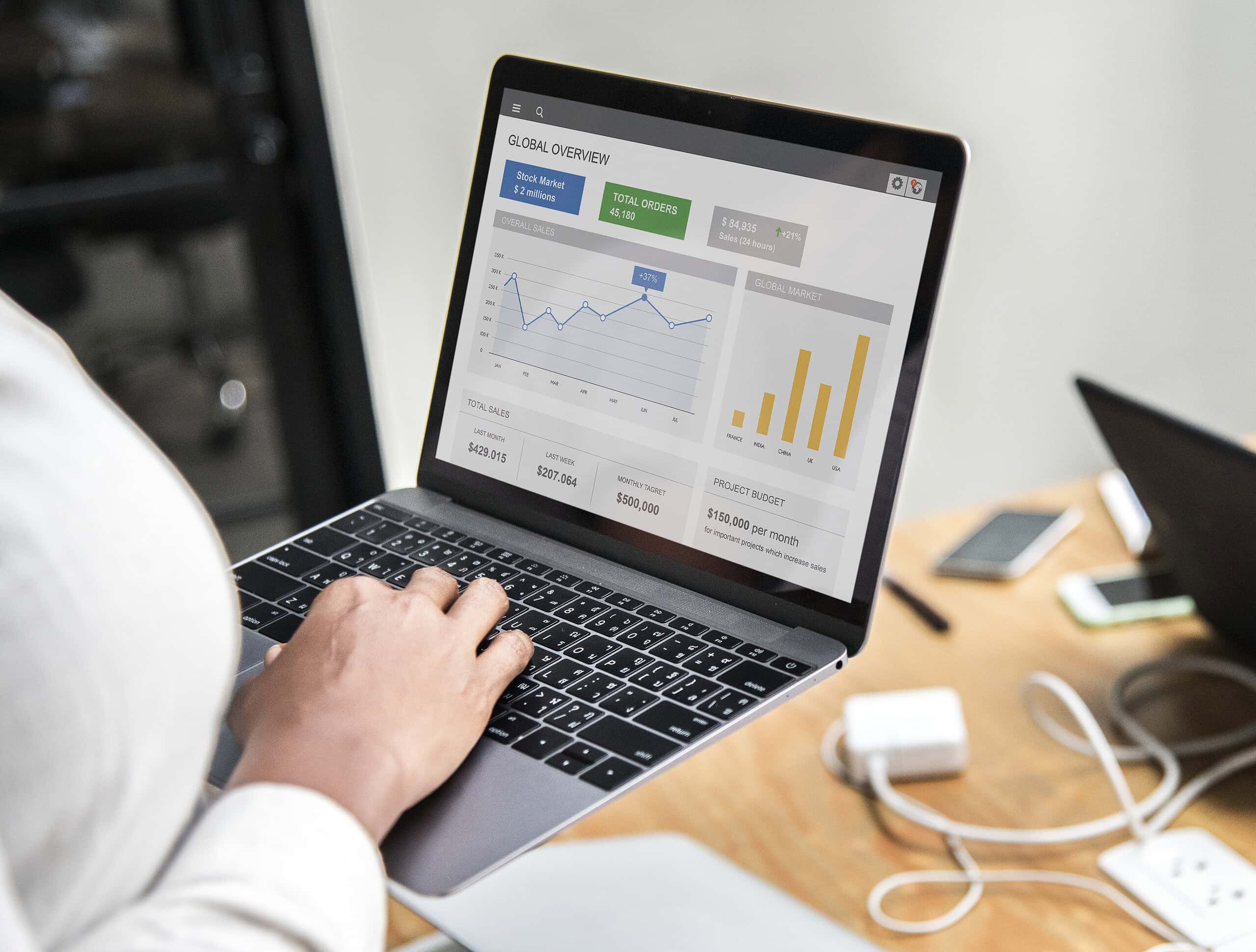 Professional developer analyzing Web Analytics Albania dashboards on a laptop to optimize e-commerce conversion tracking.